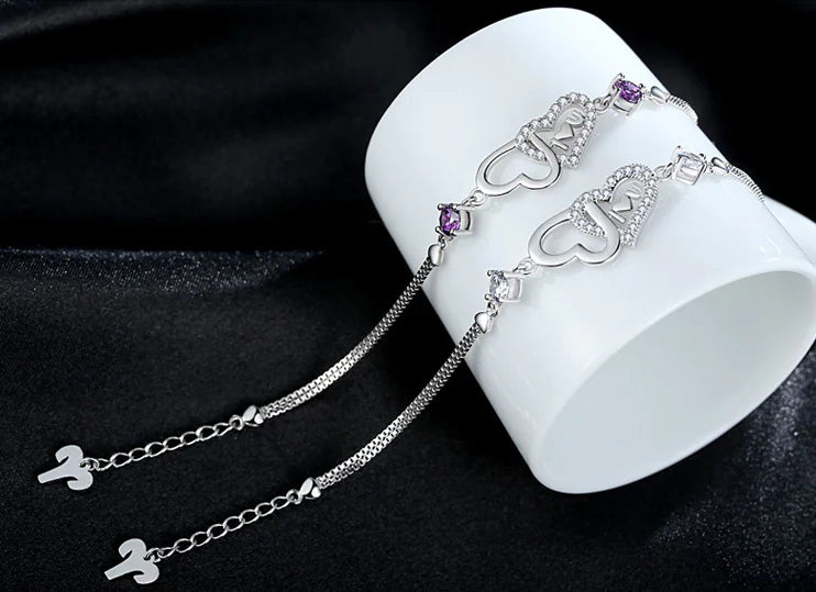 Pulsera de plata 925 con doble corazón de cristal y circonitas